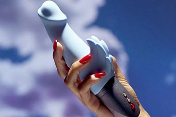 FIRST TOY REVIEW: Woohoo!, image of a hand holding a wicked wings adult toy in the air, white clouds and blue sky in the background.