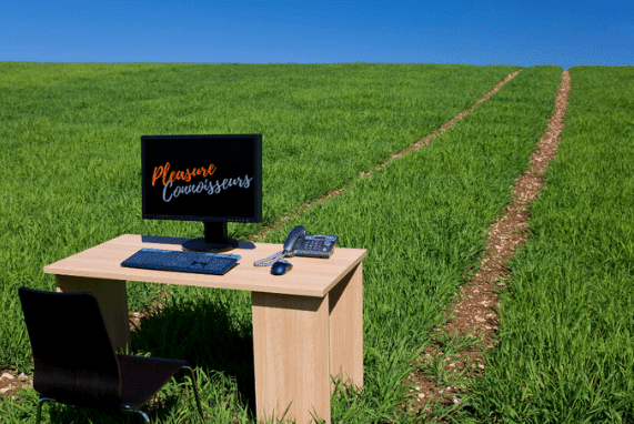 Sex Ed Classes, bright clear blue sky, desk and computer sitting on a path in green grass.