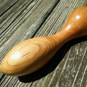 Lumberjill, adult wooden sex toy lying on a wood floor.