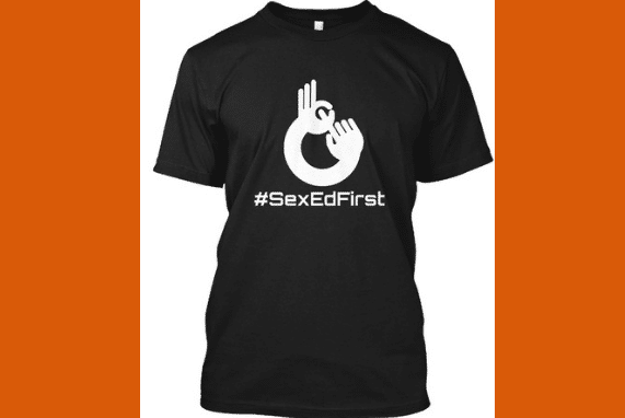 Sex Ed First black tee with white font.
