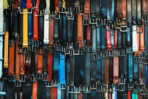 Mr. Johnson, image with many belts, all colors and the buckles are facing down on each one.